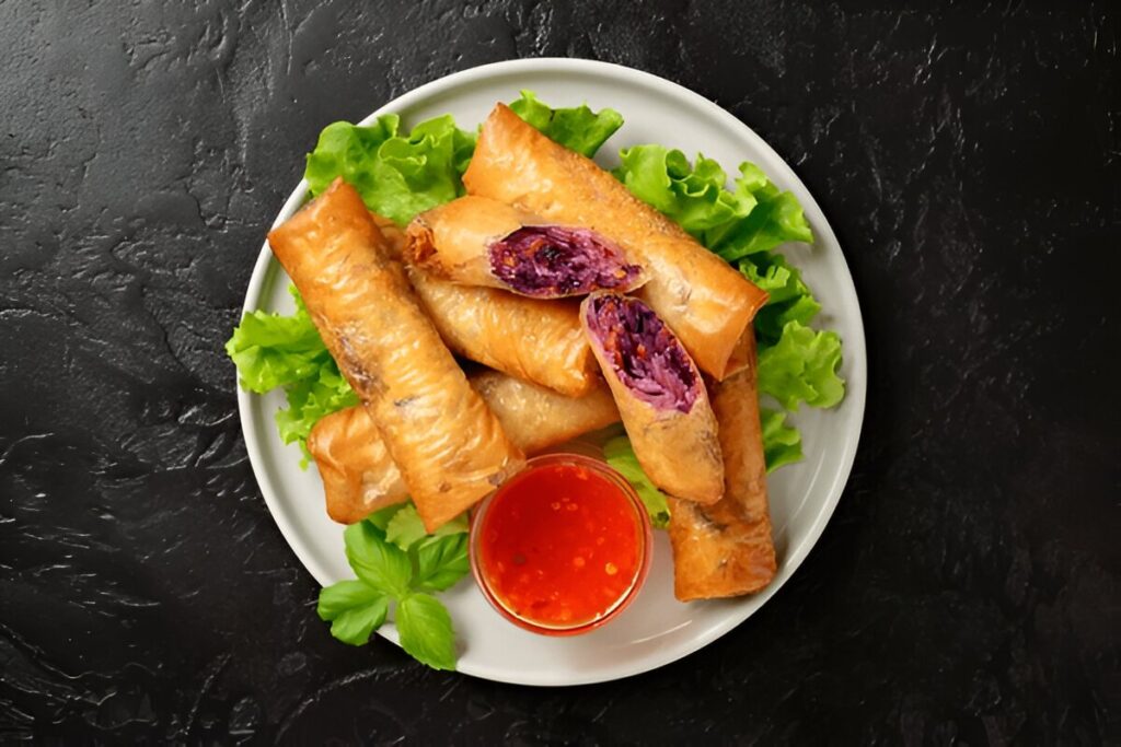 Fresh fried spring rolls stuffed with red cabbage and carrot
